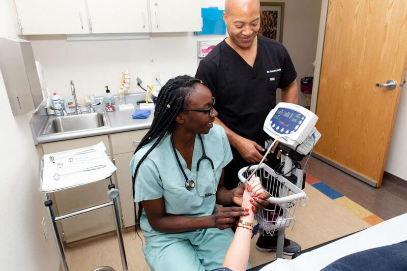 Student taking blood pressure on patient 