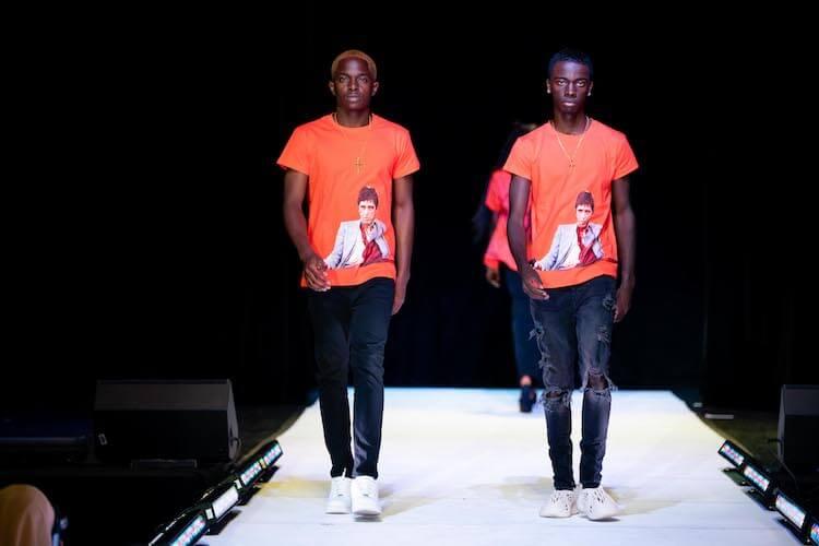 Two male models walking in Howard's annual fashion show 