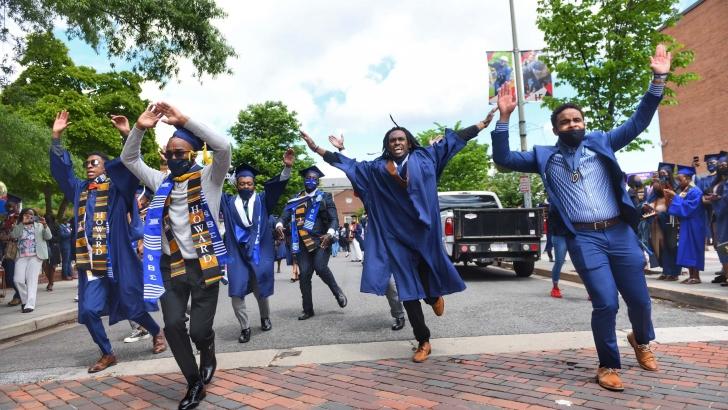 Students in street celebrating graduation