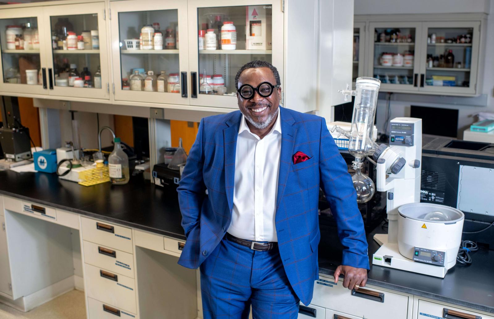 Earl Ettienne leaning against a counter in a medical lab