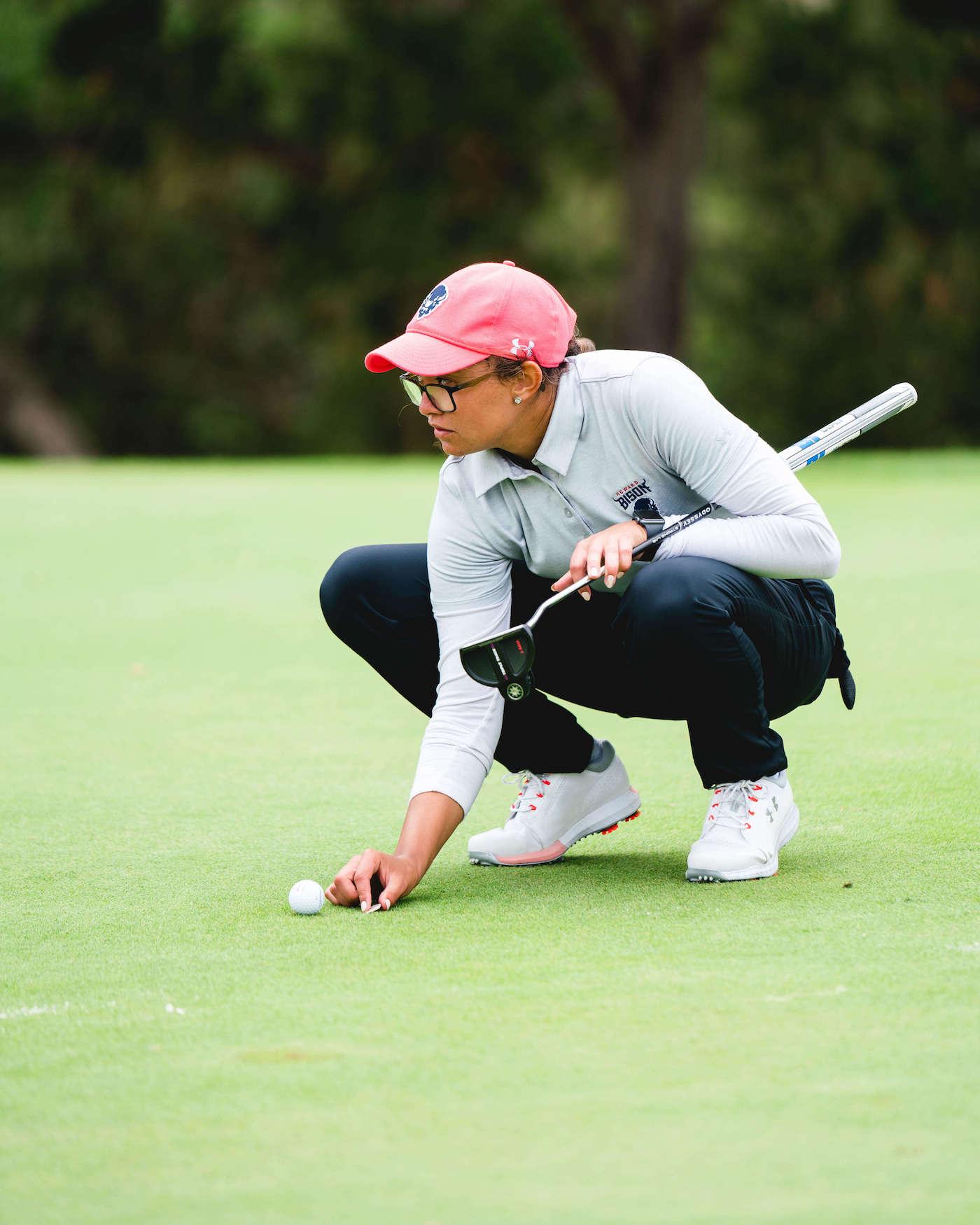 Female Howard golf team member on a golf course