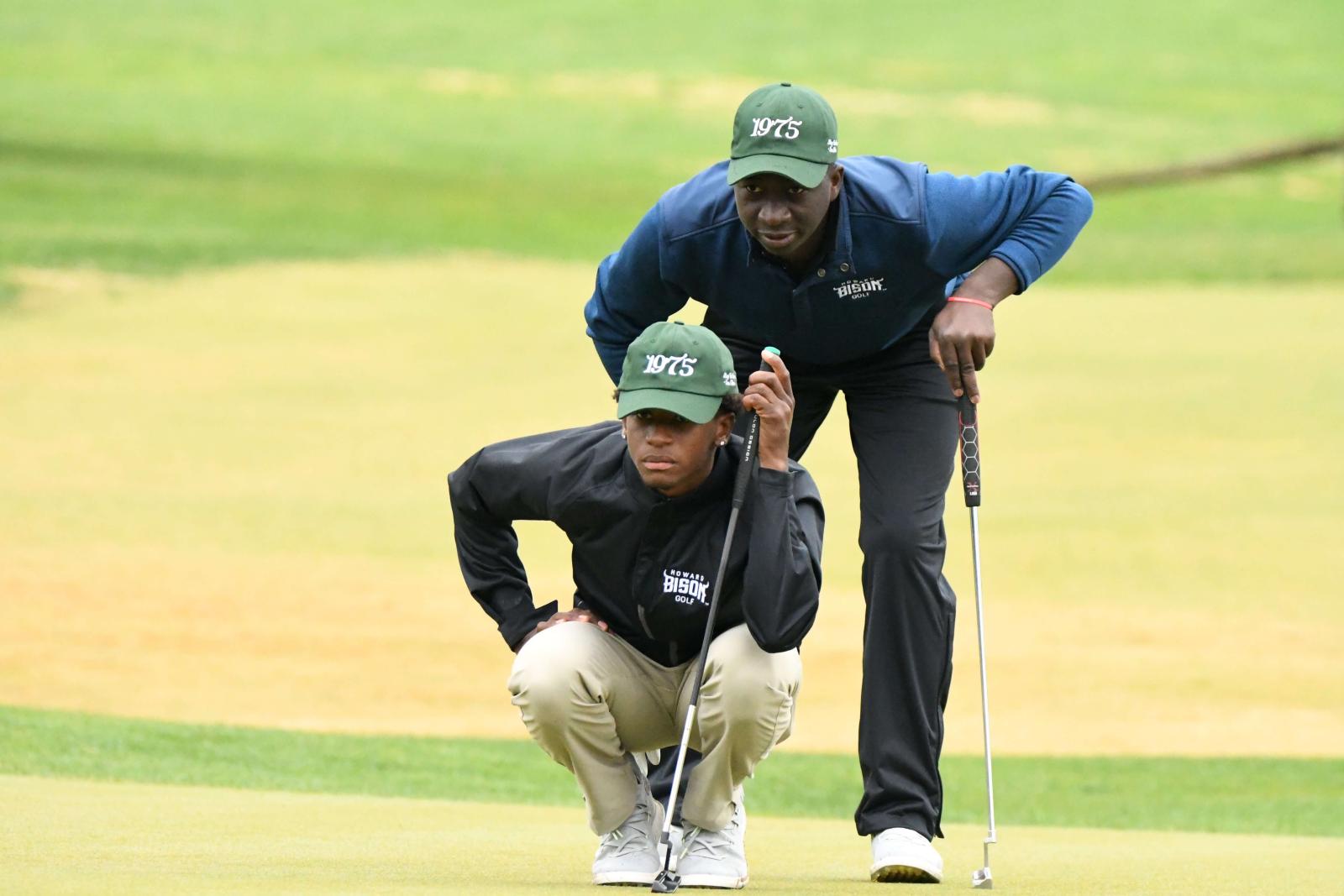Two Howard golf team member strategizing 