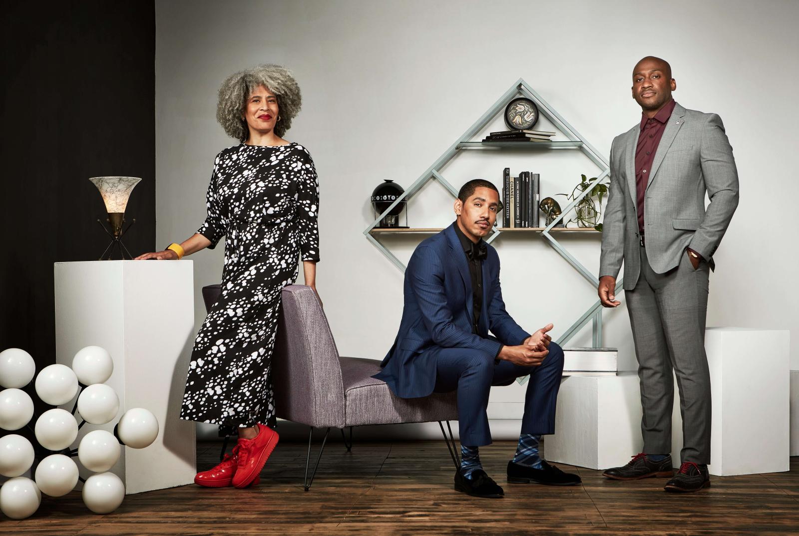 Three Howard Alumni posing in an art gallery space