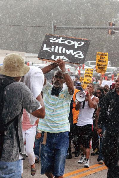 Photo by Jordan Shanks of people holding protest signs