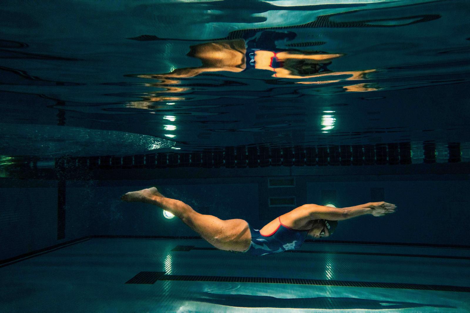 Female swimmer gliding through water