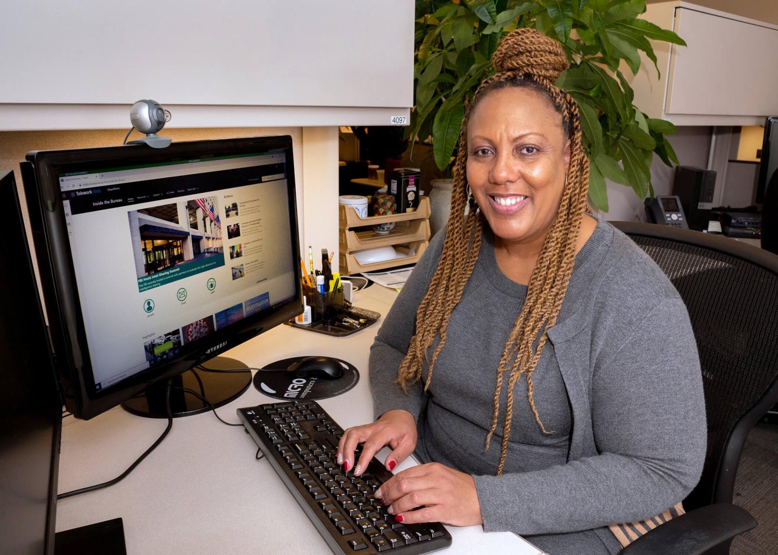 Wendi Lindler sitting at her desk typing on a computer