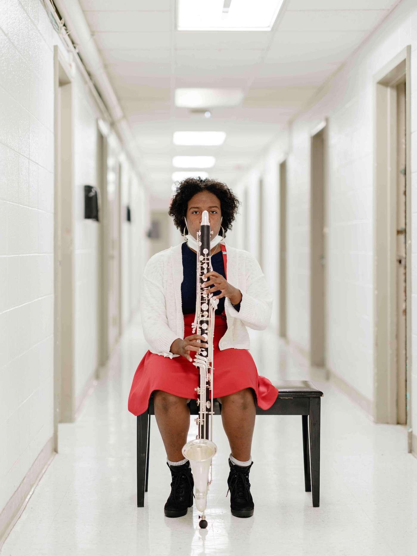 woman playing instrument in the hallway