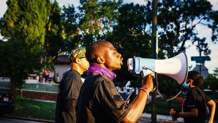 Howard student with megaphone protesting