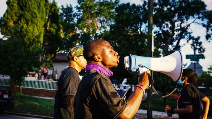 Howard student with megaphone protesting 