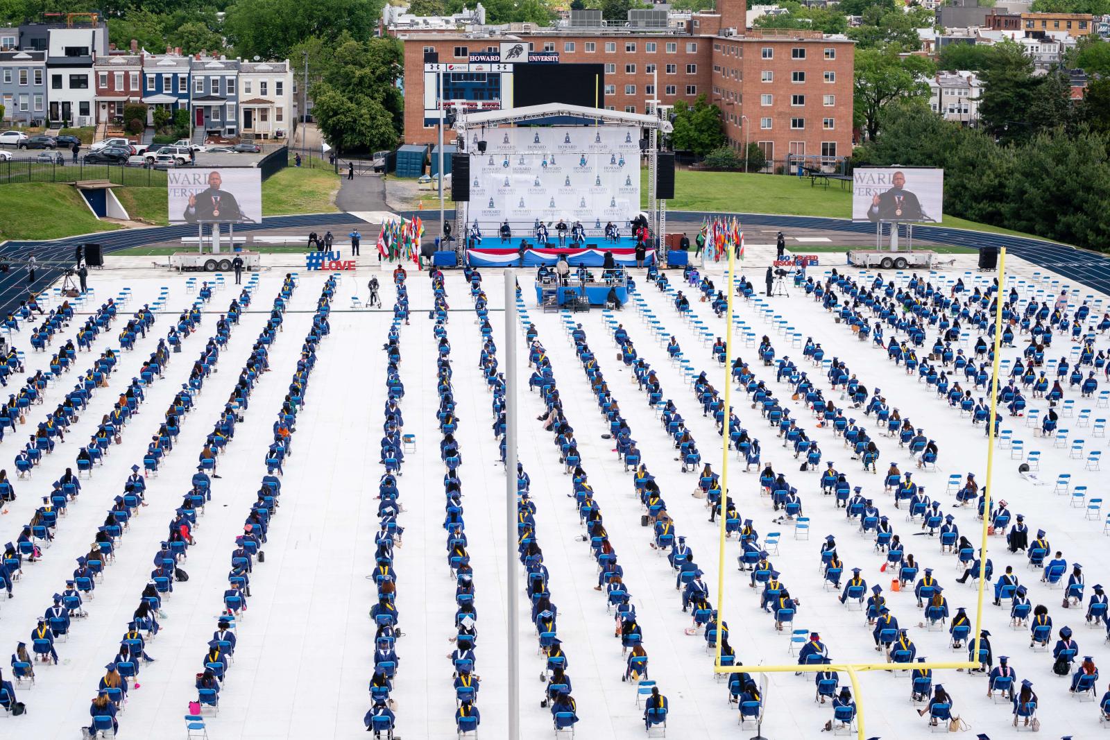Aerial photo of students sitting on football field for graduation