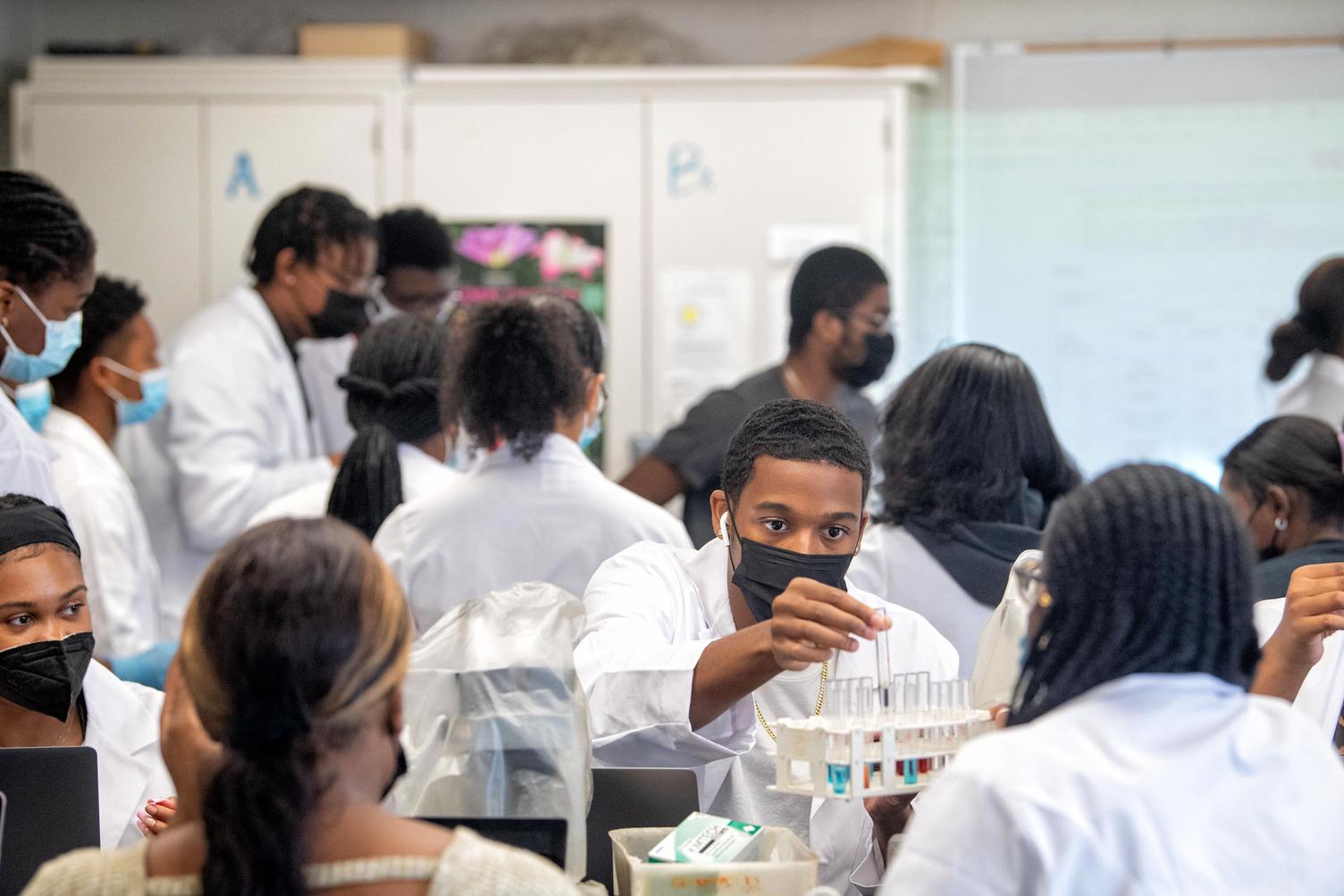 Students in lab coats working on research