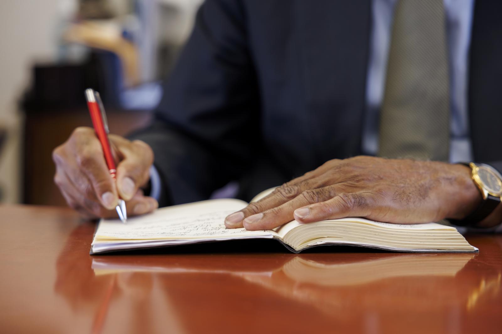 Dr Cosby writing in a notebook