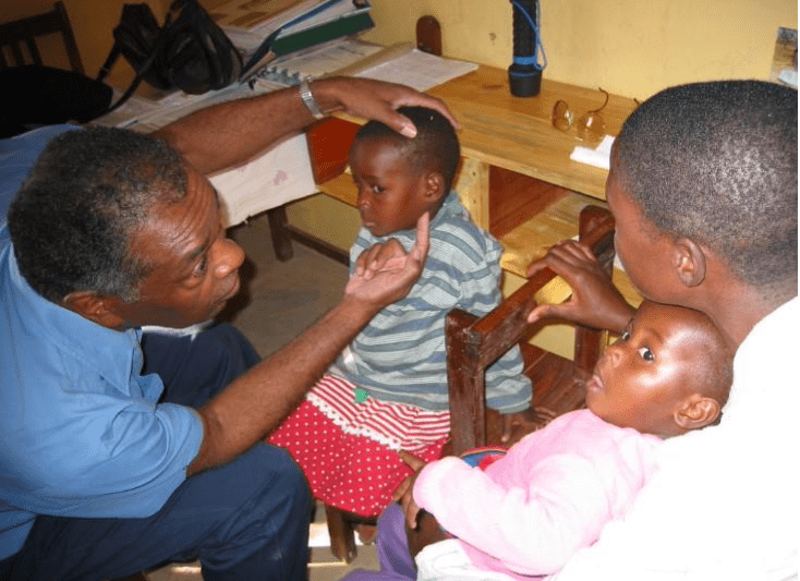 Irving Williams with small child patient