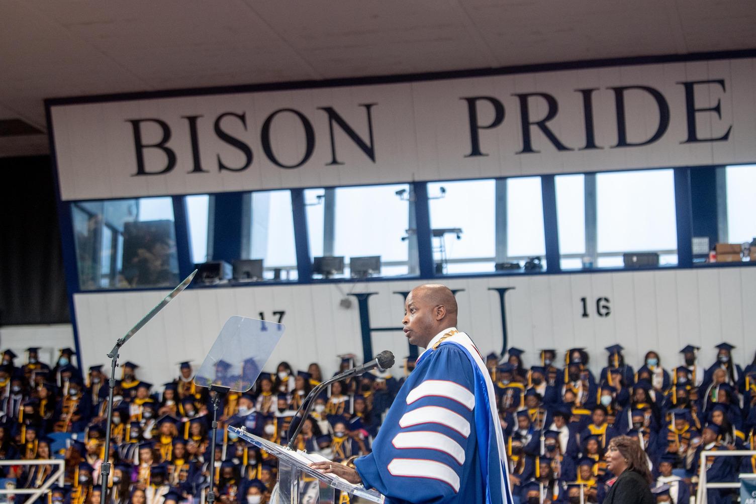 Dr. Frederick in front of Bison Pride sign