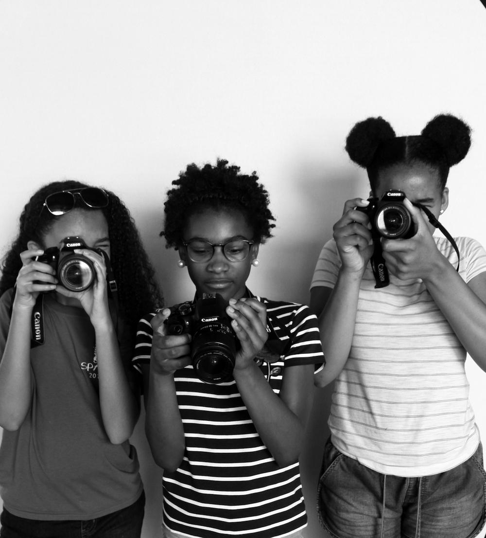 three girls with cameras
