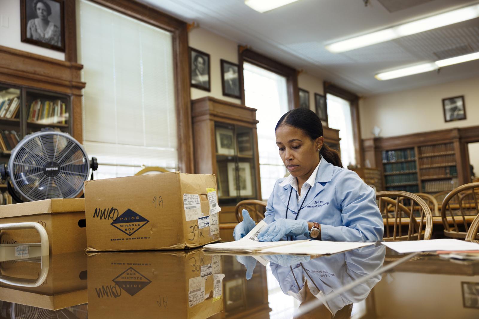 archivist going through archives at Moorland-Spingarn