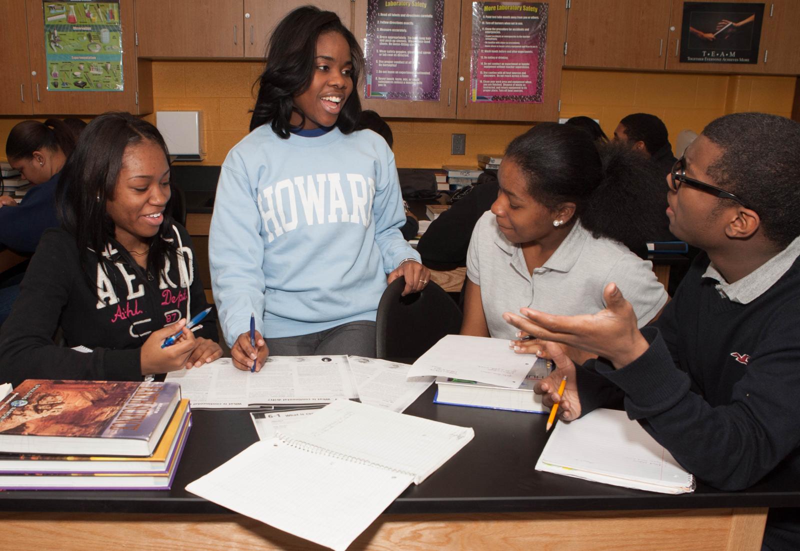 Andreya Davis with other Howard students over papers
