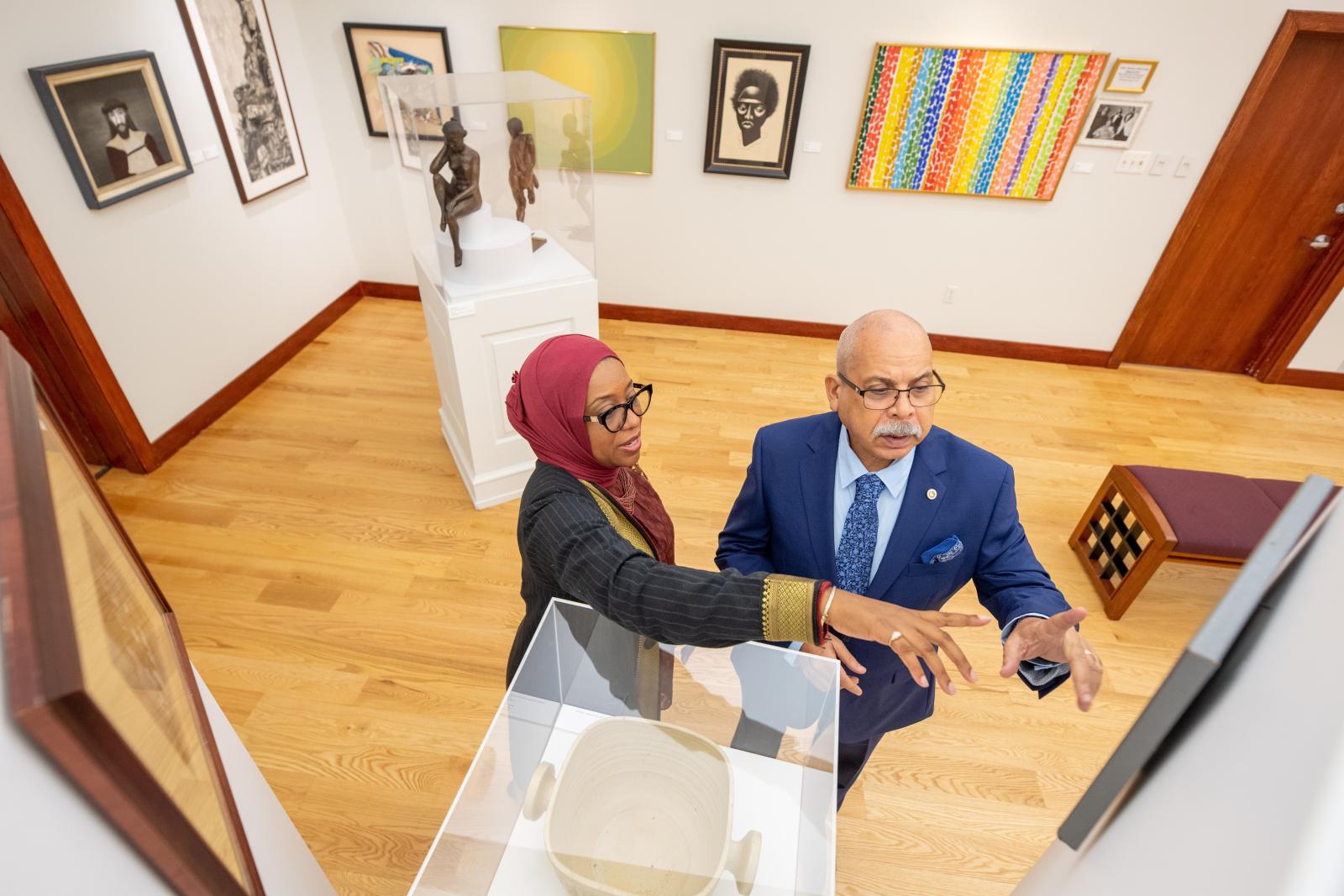 Raul Ferrera-Balanquet and Kathryn E. Coney-Ali examine a work of art