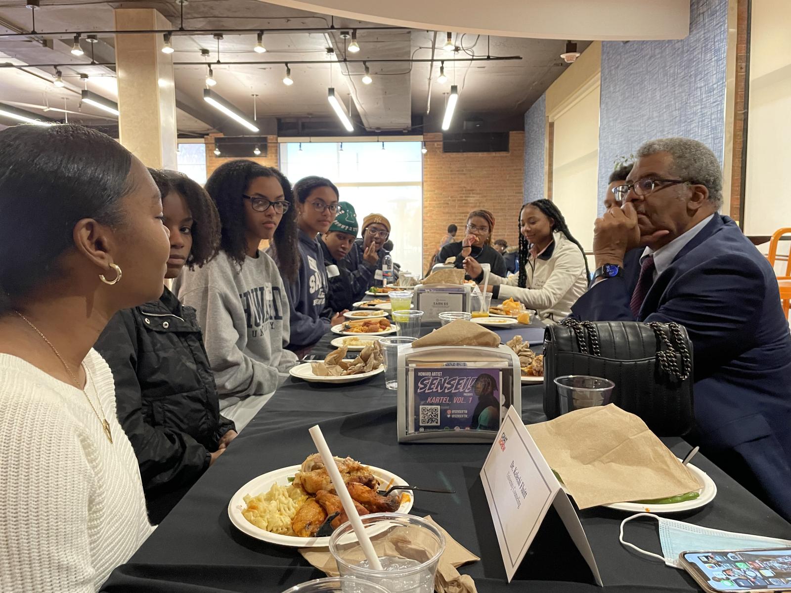 Students dining with administrators