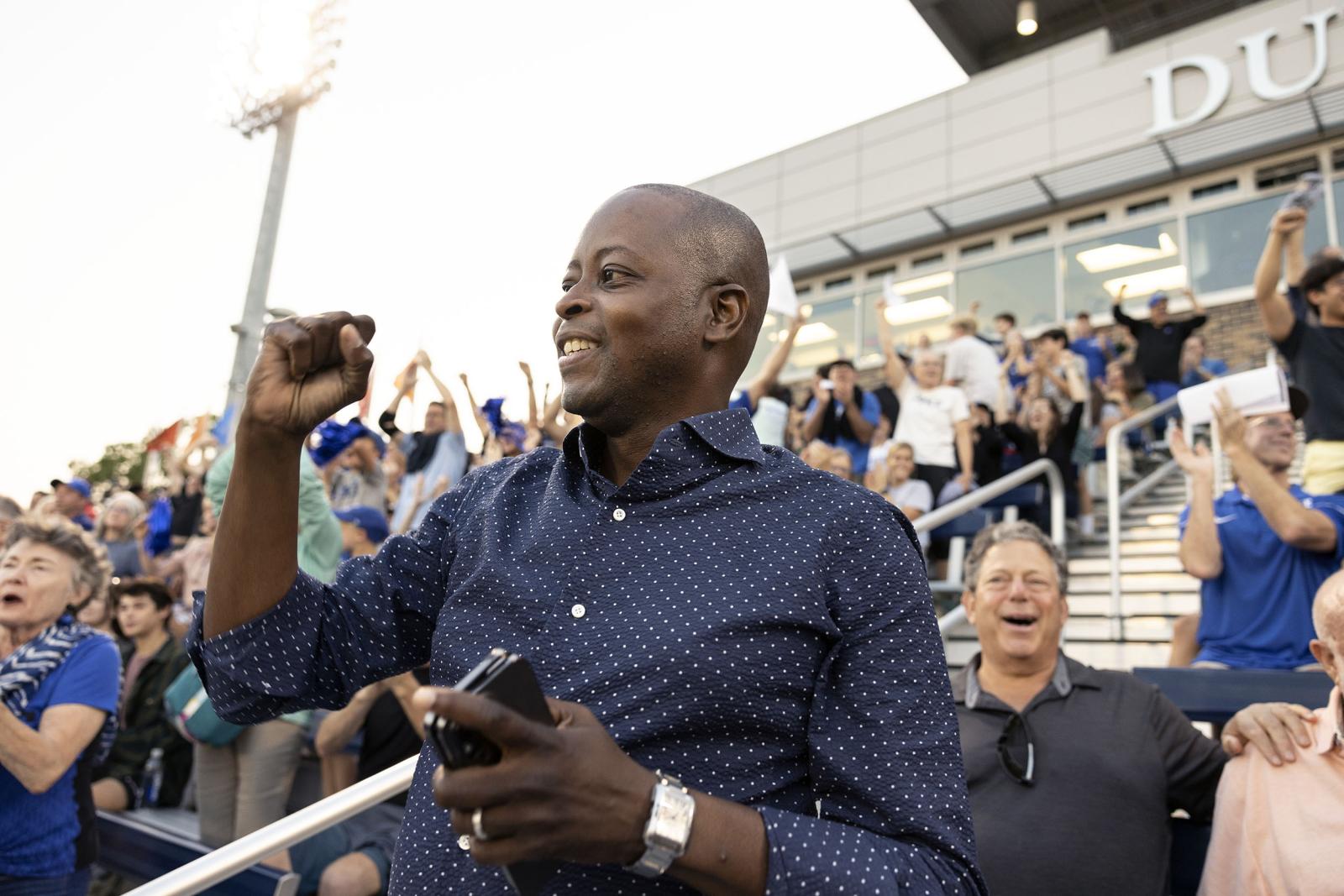 Dr. Frederick cheering in stands