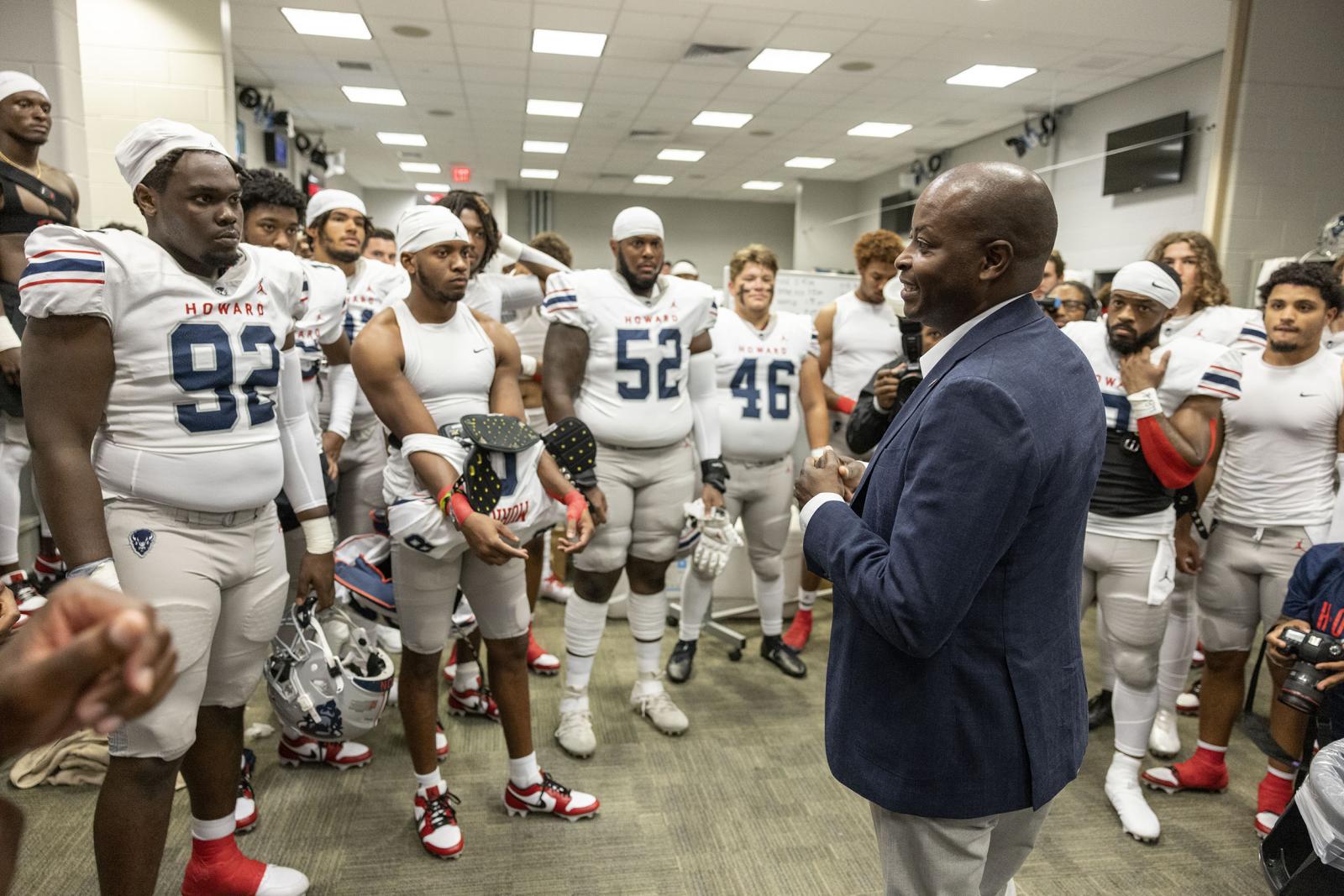 Dr. Frederick with football team inside locker room