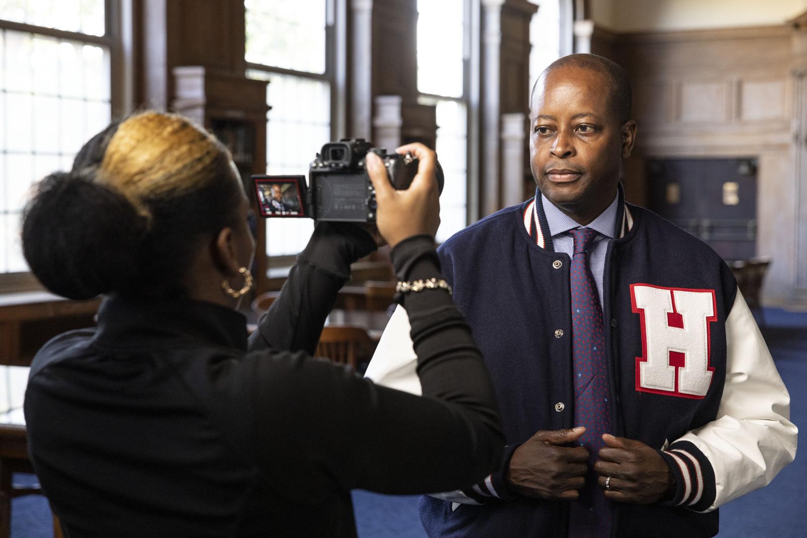 Dr. Frederick in letterman jacket with camera recording