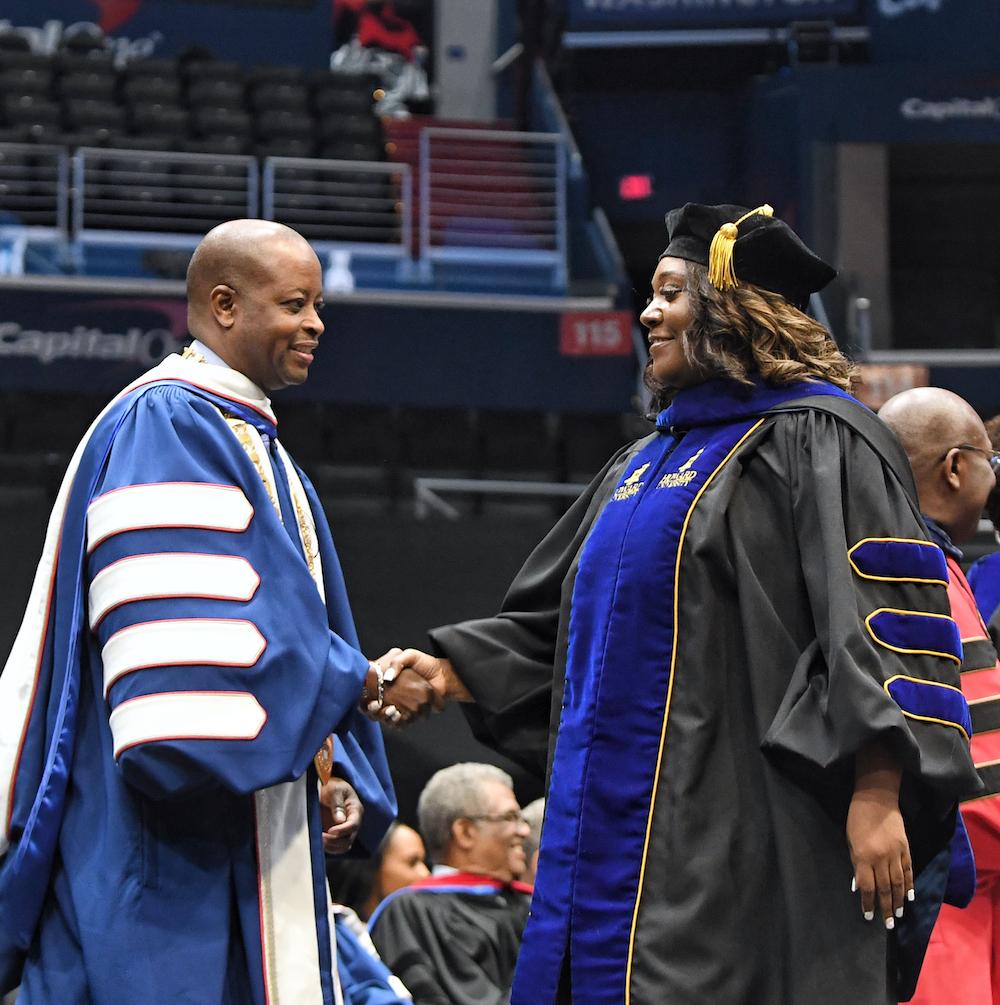 Dr. Frederick shakes graduate's hand