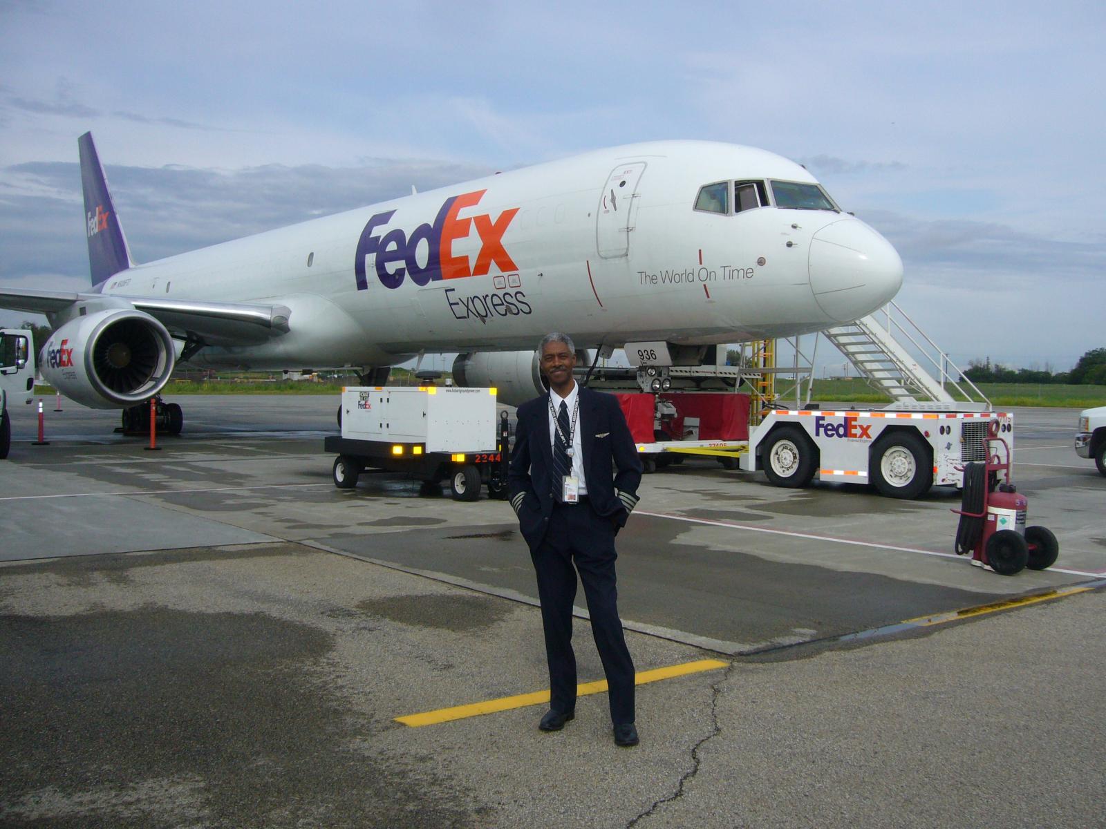Pilot Hank Taylor in front of FedEx plane
