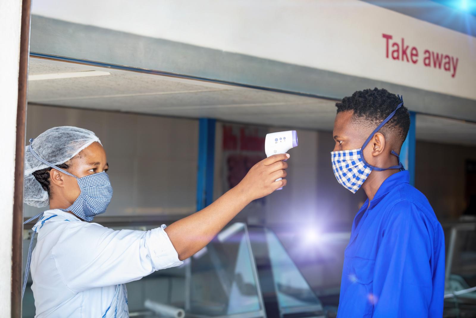 nurse scanning forehead with thermometer