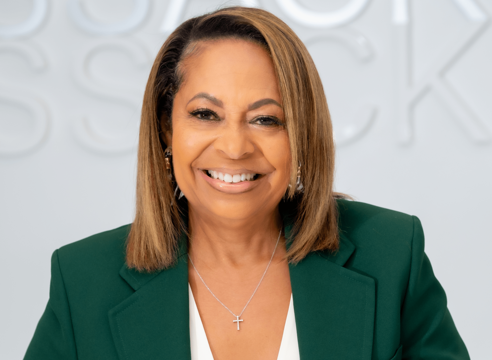 McKissack headshot photo with her smiling in an emerald green suit.