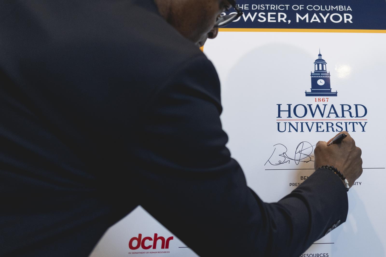 President Vinson signing Mayor Bowser's HBCU Public Service Program board