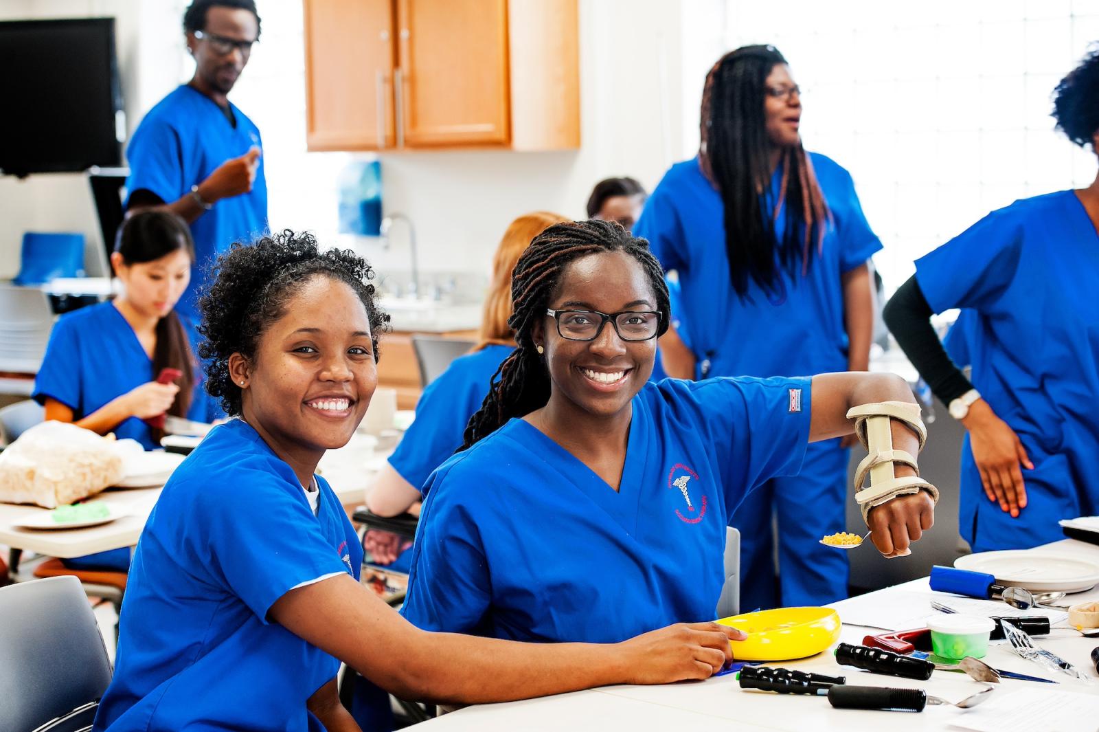Nursing students in blue uniforms