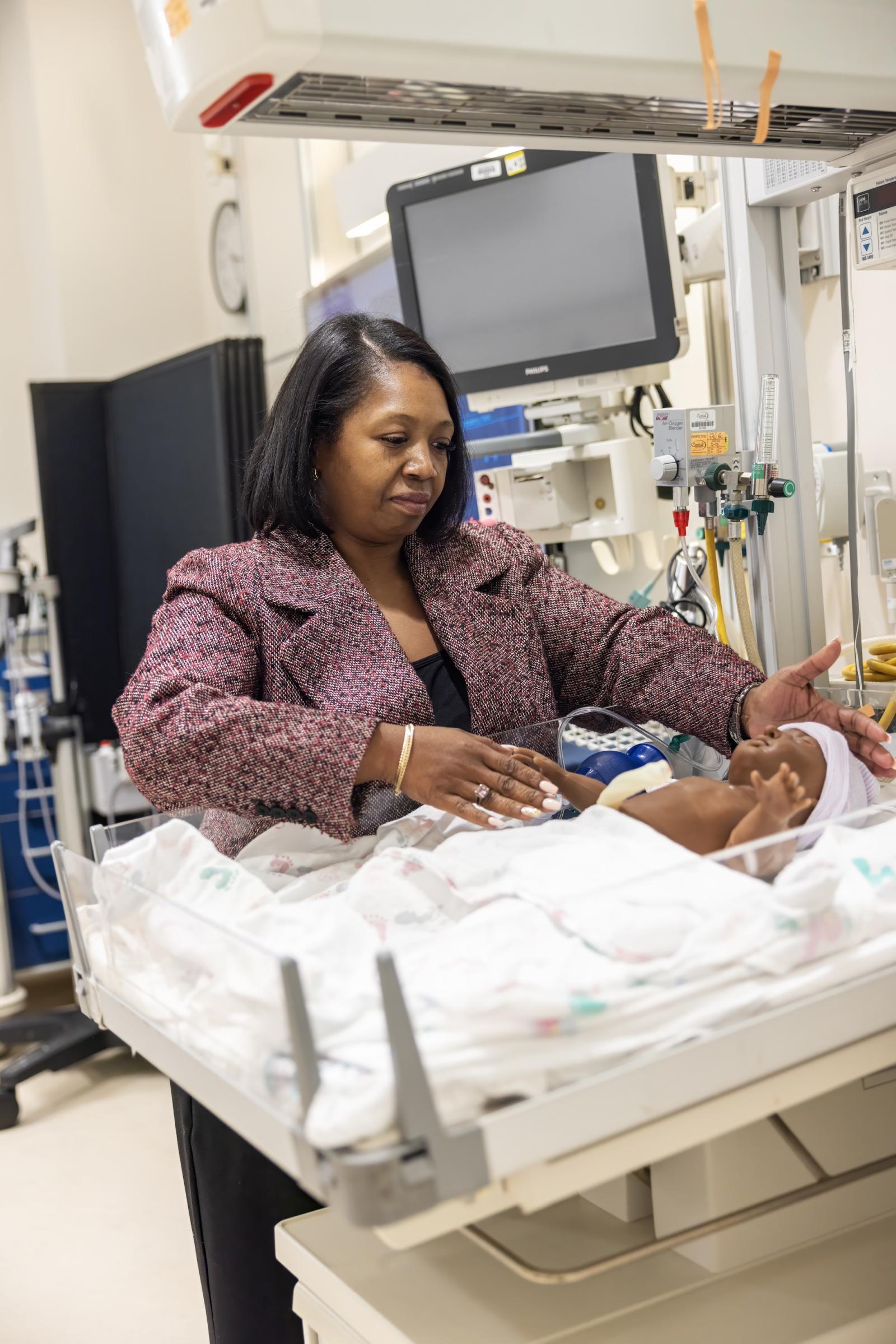 Dr. Owens with mannequin newborn