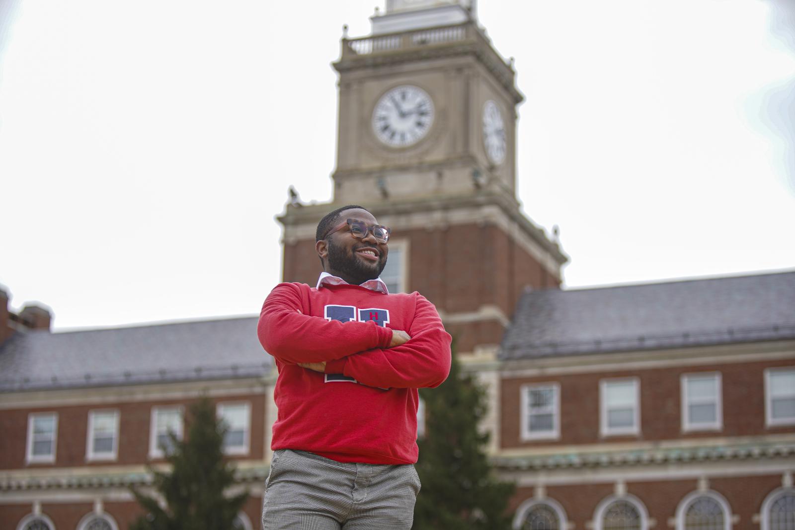 Howard University student in front of Founders Library. 