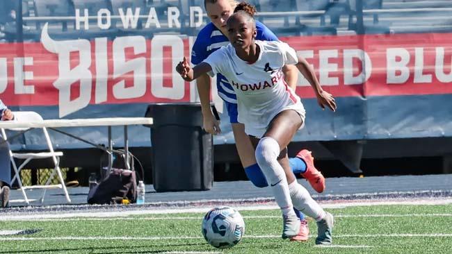 Howard University soccer player prepares to kick the ball. 