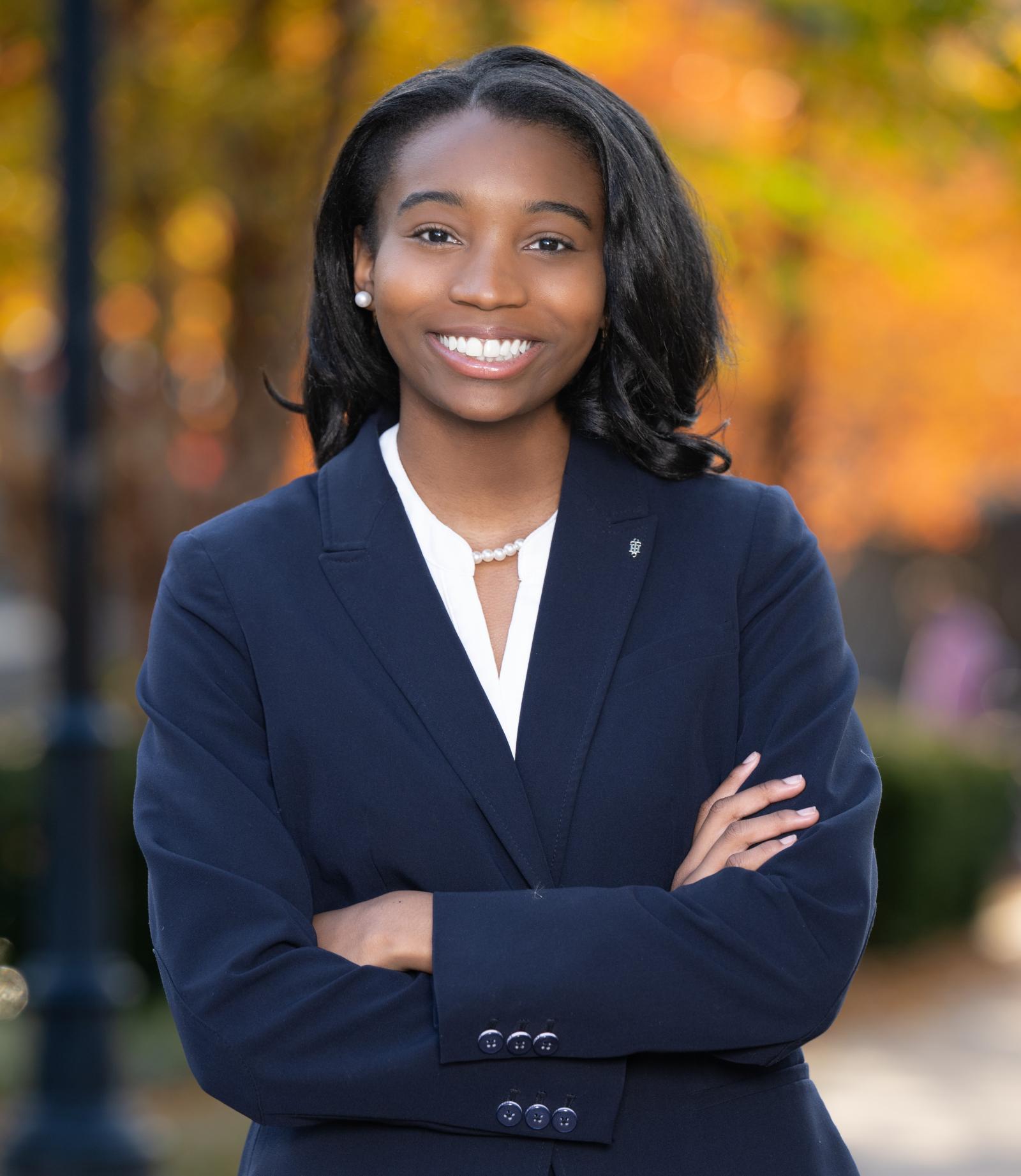 Howard business student with arms crossed.