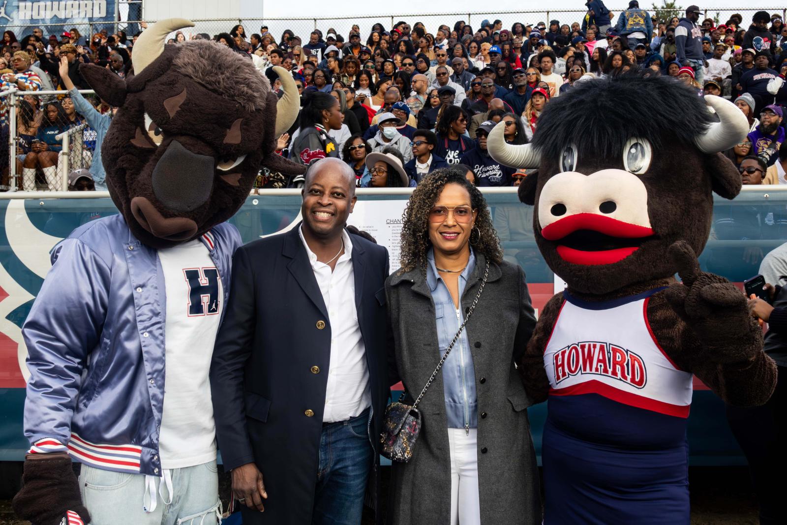 President Frederick and his wife standing beside two Howard Bison mascots during Homecoming 2025